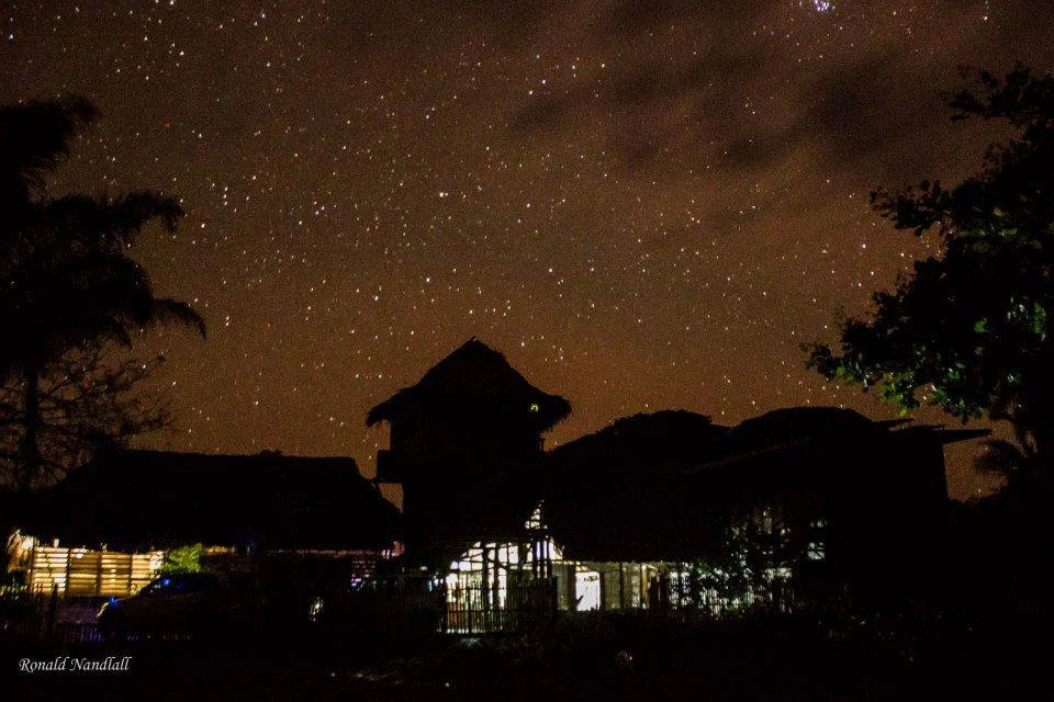 Caiman House at night under the stars